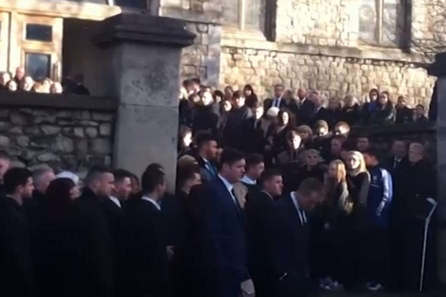 Mourners gather outside St Nicholas Church in Strood