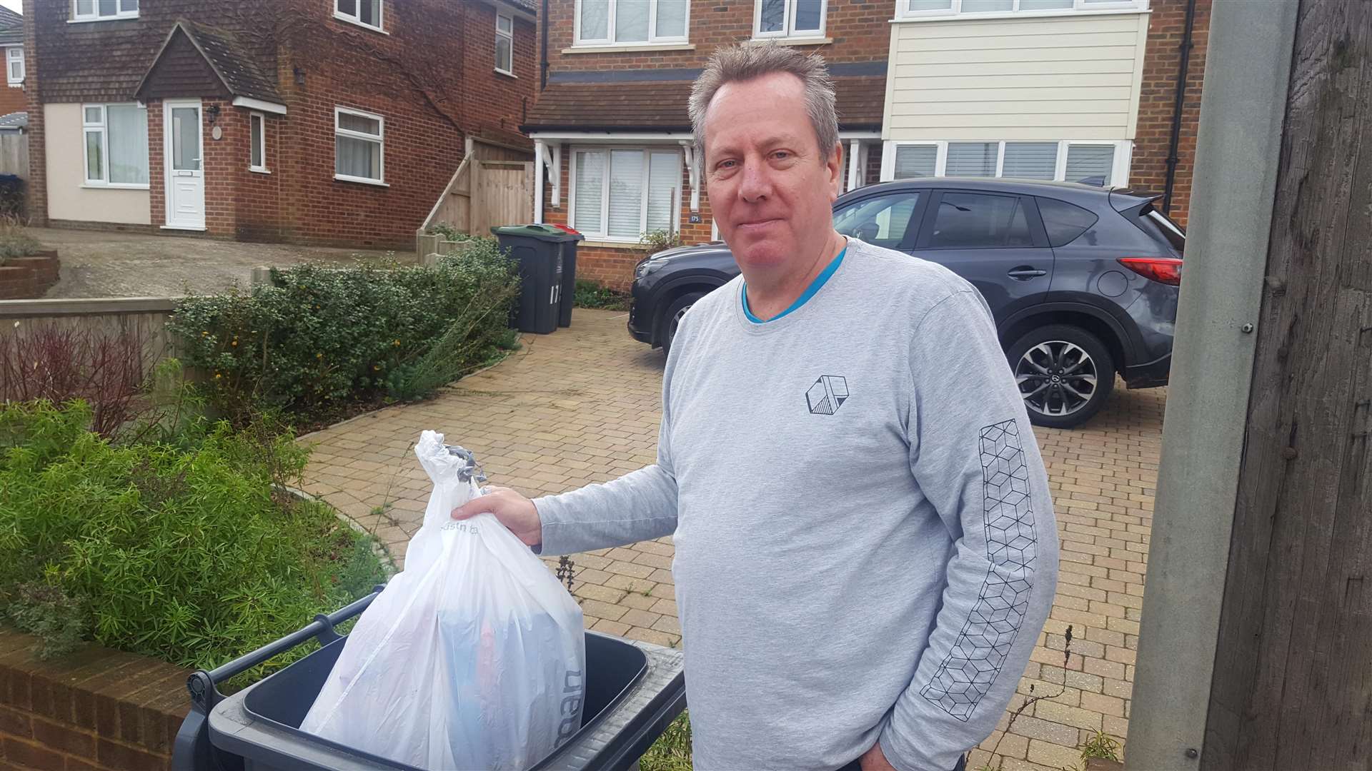 Ian McMillan with his half emptied bin