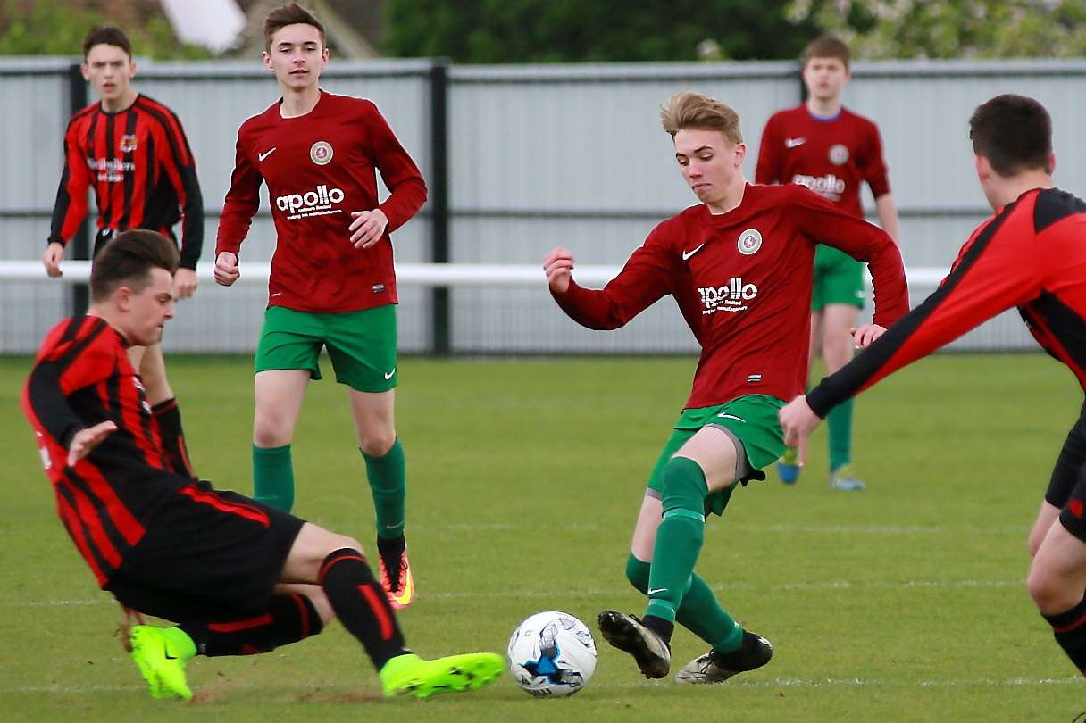 Woodcoombe Youth left, challenge Cobham Colts in the Under-16 League Cup final Picture: Phil Lee