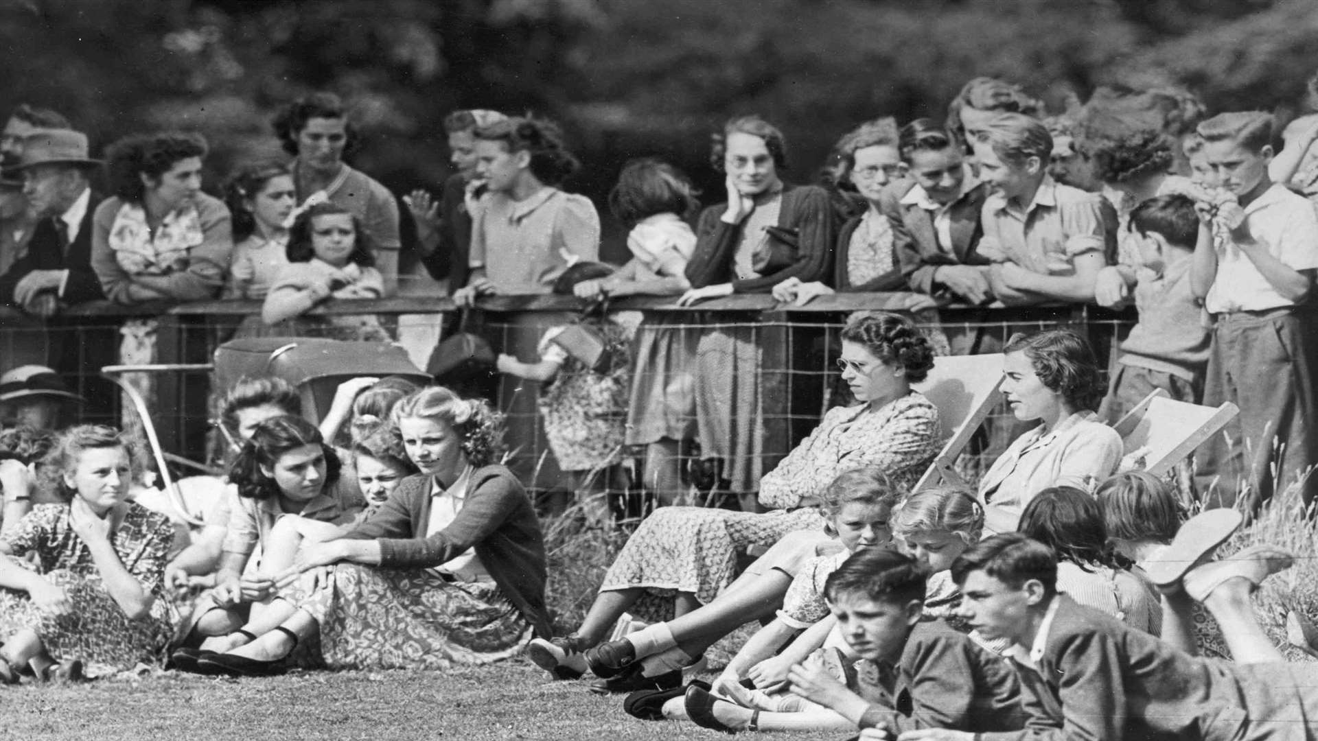The Queen and Lady Brabourne relax in deck chairs watching cricket at Mersham-le-Hatch