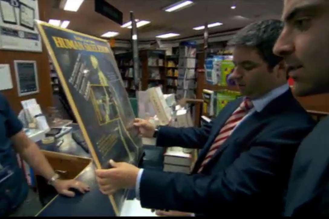 The paper skeleton is examined in the shop as Felipe makes the fatal decision to buy it