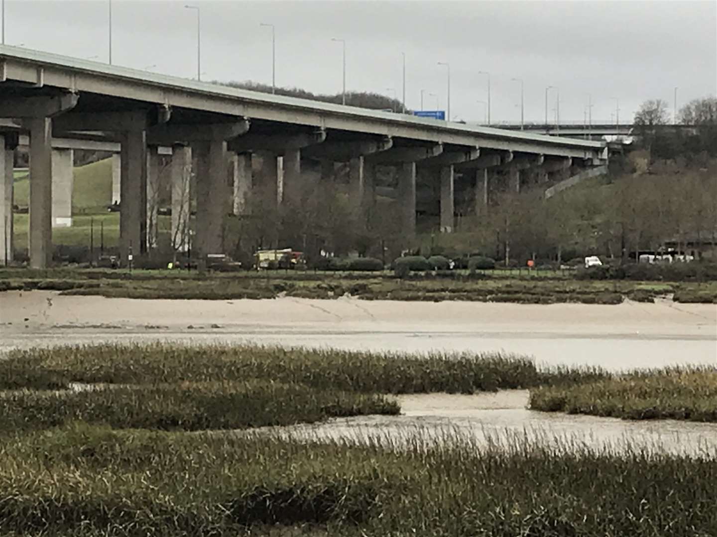 Fire engines and police are gathered on the banks of the River Medway near the M2 bridge