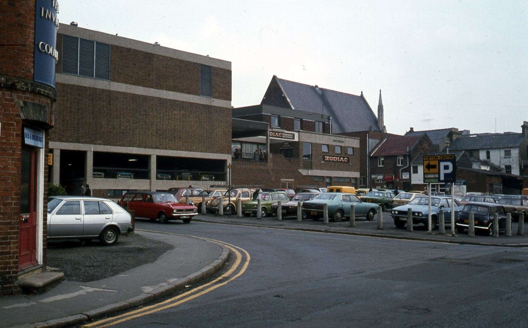 1976 - The entrance to the Tufton Centre underground car park in Hempsted Street (left) with the busy council-run open-air car park in Godinton Road (right). Picture: Steve Salter