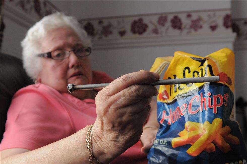 Jean holds the bolt next to the bag of chips
