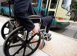 Wheelchair user waiting for a bus