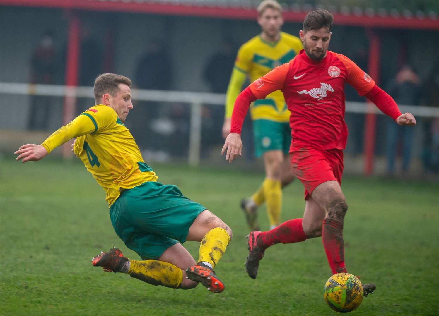 Josh Wisson challenges Hythe player-boss James Rogers Picture: Ashford United