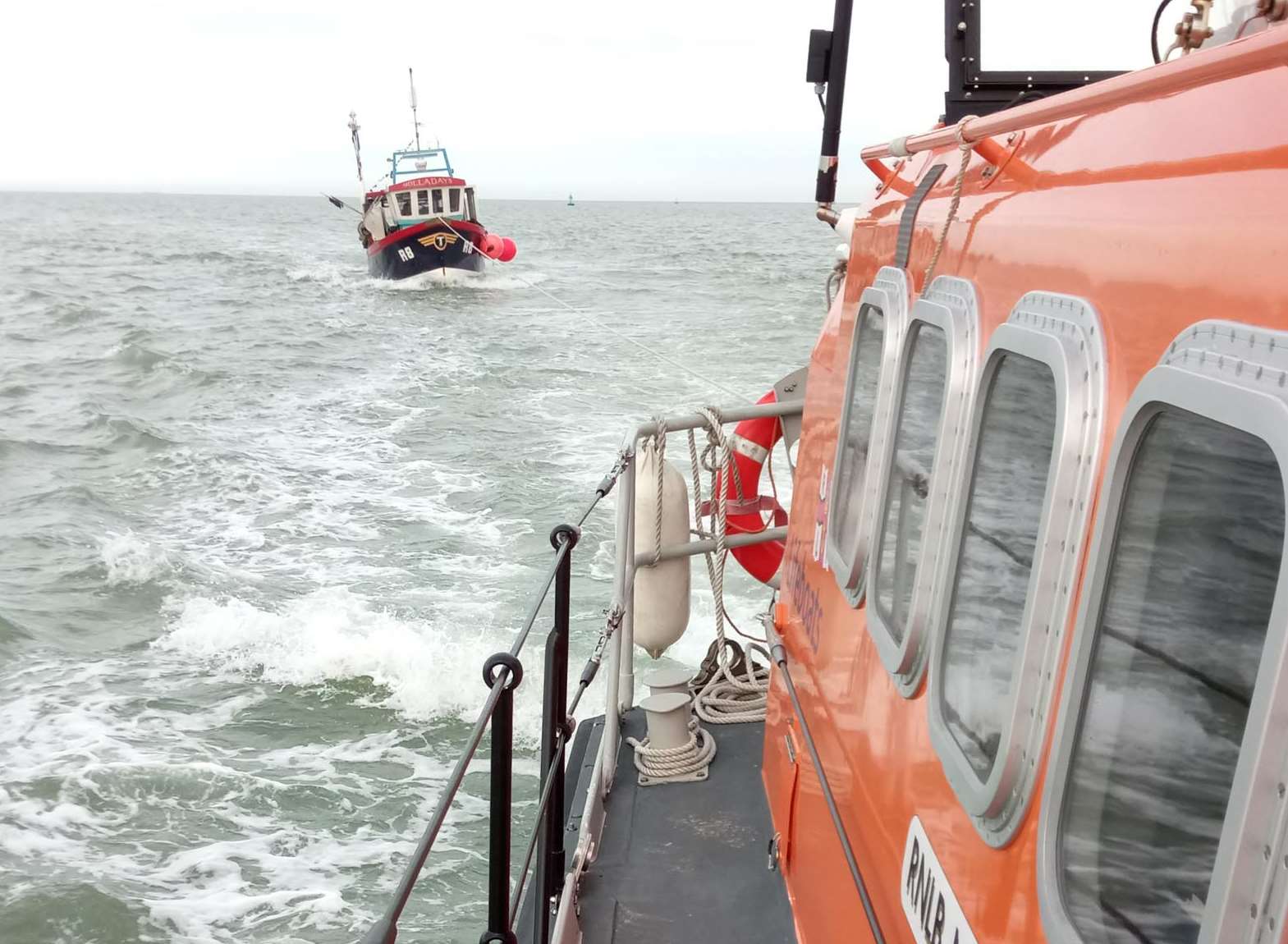 The lifeboat towing the fishing vessel. Picture: RNLI