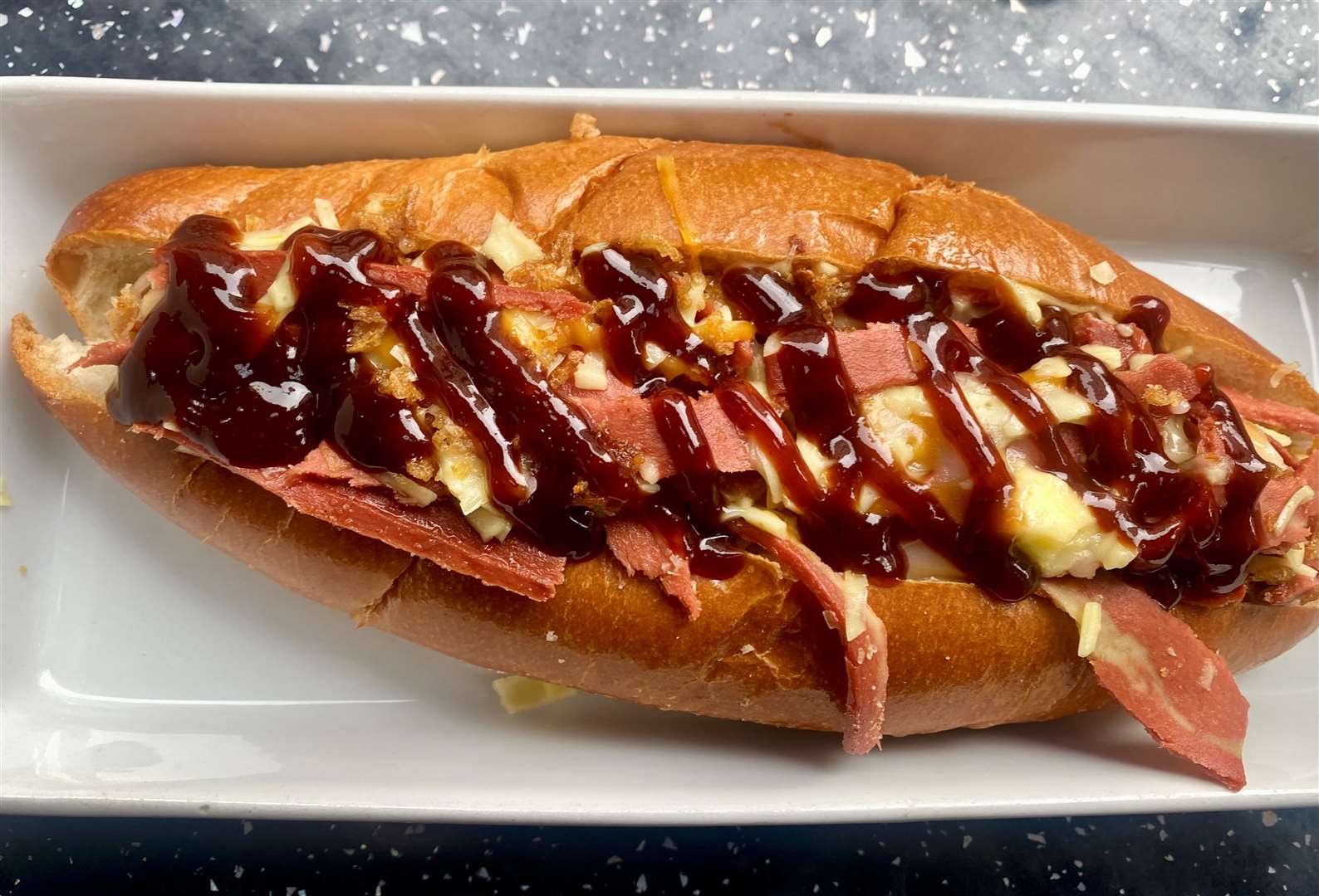 The bourbon hot dog was a Bavarian sausage in a soft roll topped with BBQ sauce, onions, 'cheeze' and vegetarian bacon bits