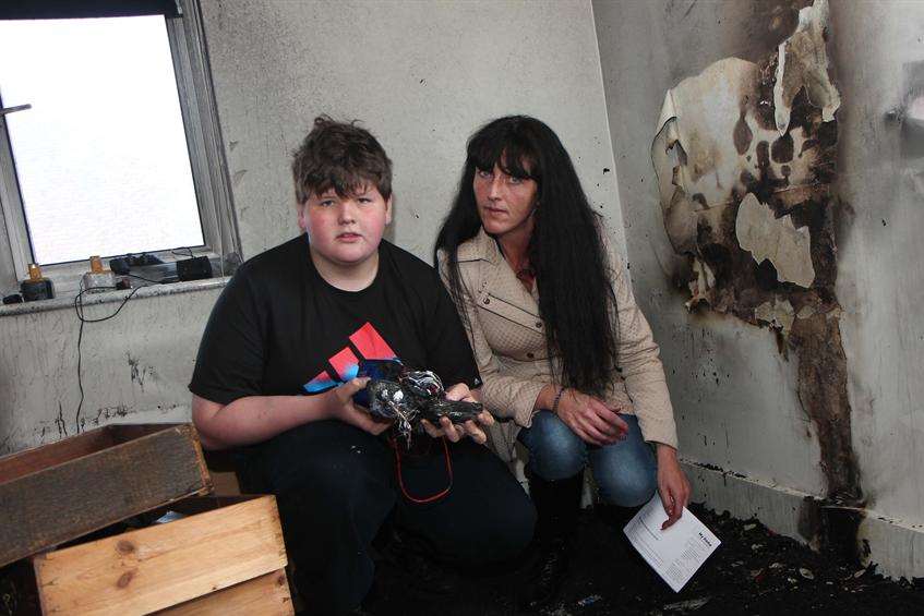 Harry Carfrae and his mum Claire Butler in his burnt out bedroom