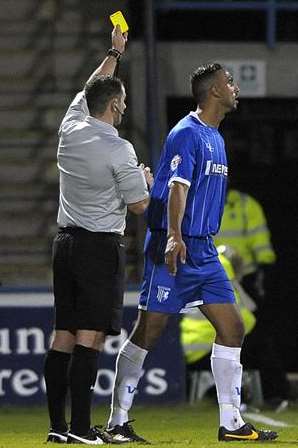 Leon Legge walks away after being booked against Peterborough. Picture: Barry Goodwin