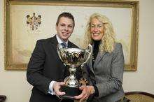 Ben Green, from Denne Construction, and Mandy Holdstock, from Hempstead House Hotel, with a trophy for the winner.
