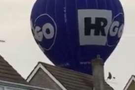 The balloon flew low over the tops of houses. Picture by Jason Sanders.