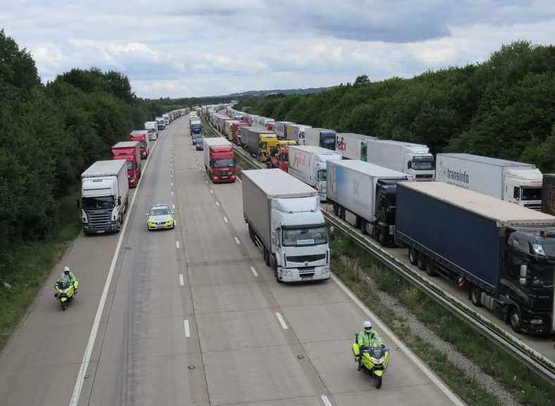 Operation Stack: Police escort lorries through the London-bound M20 at junction 9. Picture: Andy Clark.