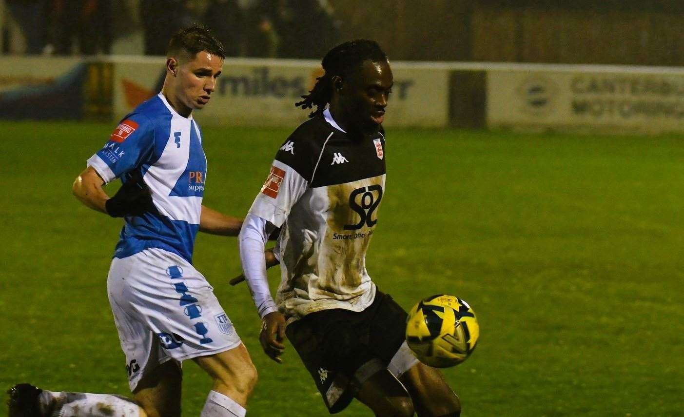 Faversham's Antone Douglas is closed down by Sheppey striker Jake Embery. Picture: Marc Richards