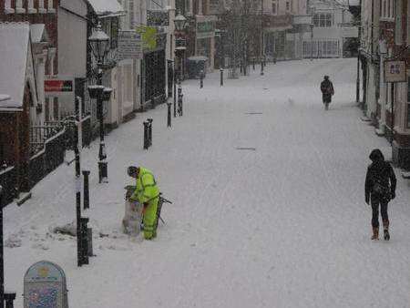A worker collects rubbish in Ashford