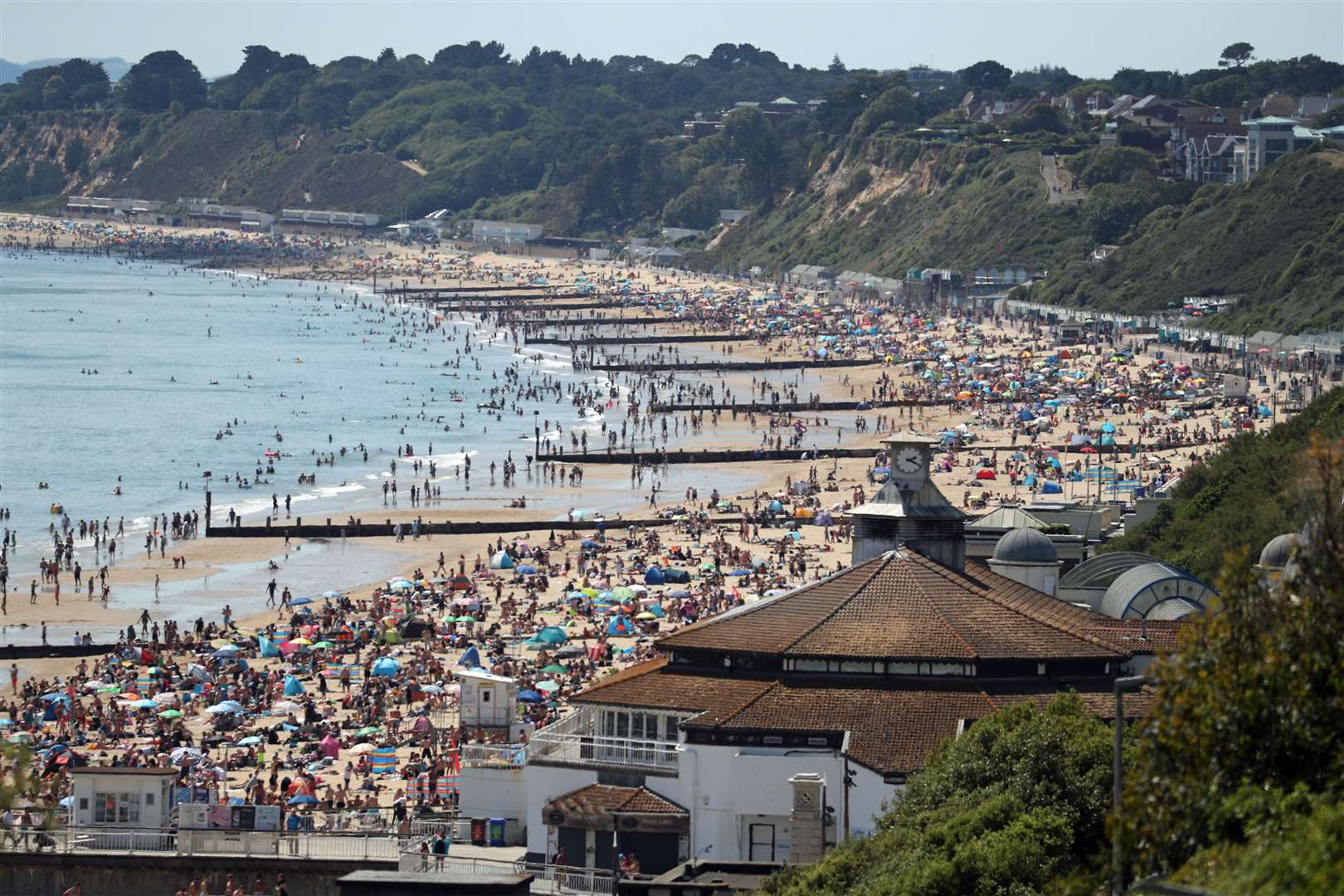People crowd on the beach in Bournemouth, Dorset, in June despite the public being reminded to practise social distancing following the relaxation of the coronavirus lockdown restrictions in England (Andrew Matthews/PA)