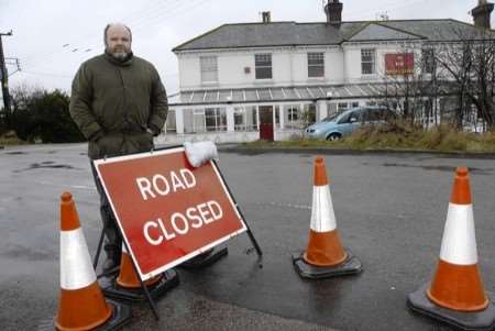 Sportsman licensee Phil Harris by the road closure sign.