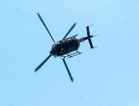 The police helicopter hovers over the scene