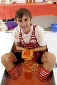 Ross Waldron, sits in a bath full of baked beans for charity. Whitefriars, Canterbury
