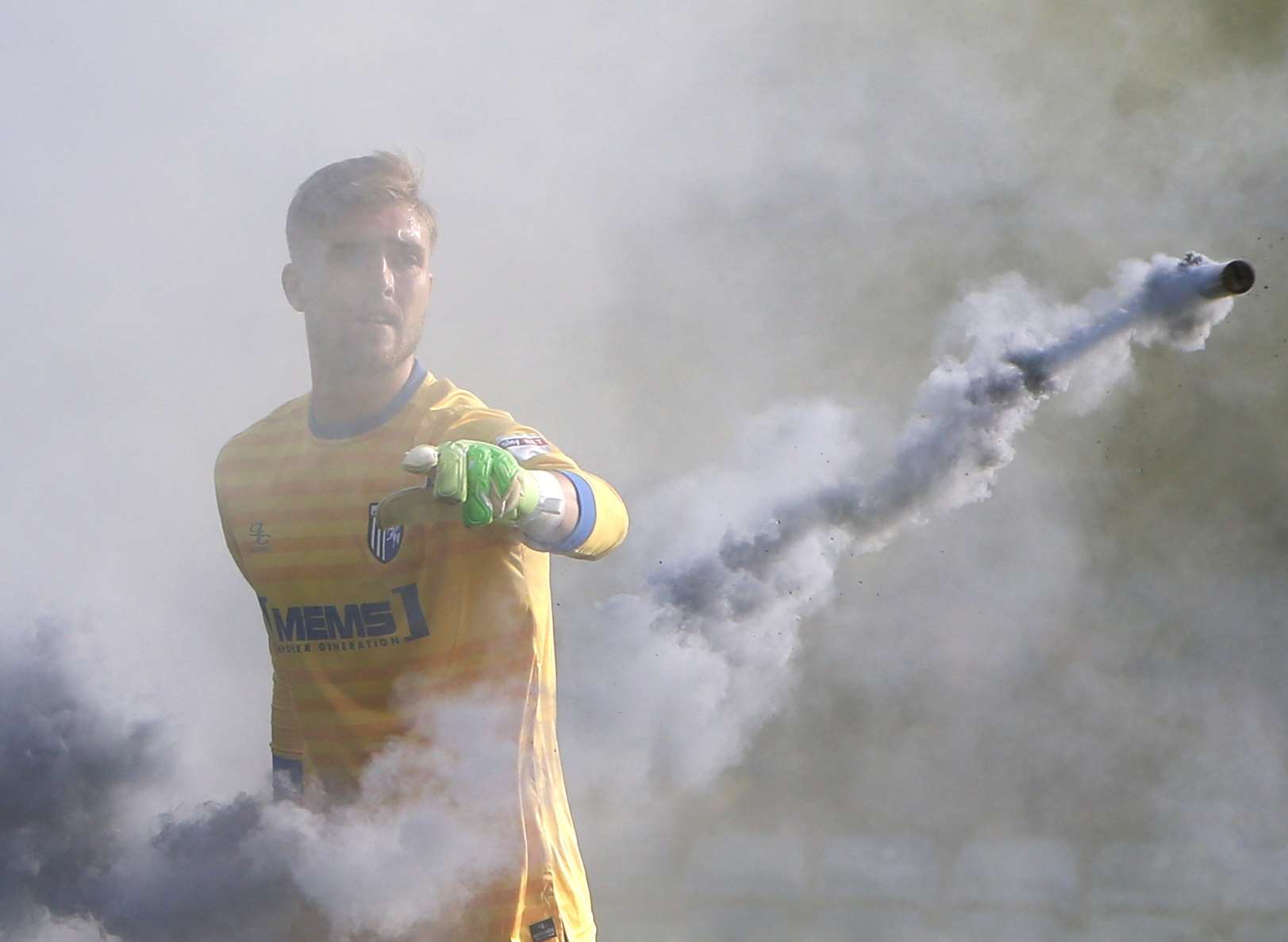 Tomas Holy throws a smoke bomb off the pitch. Picture: Andy Jones