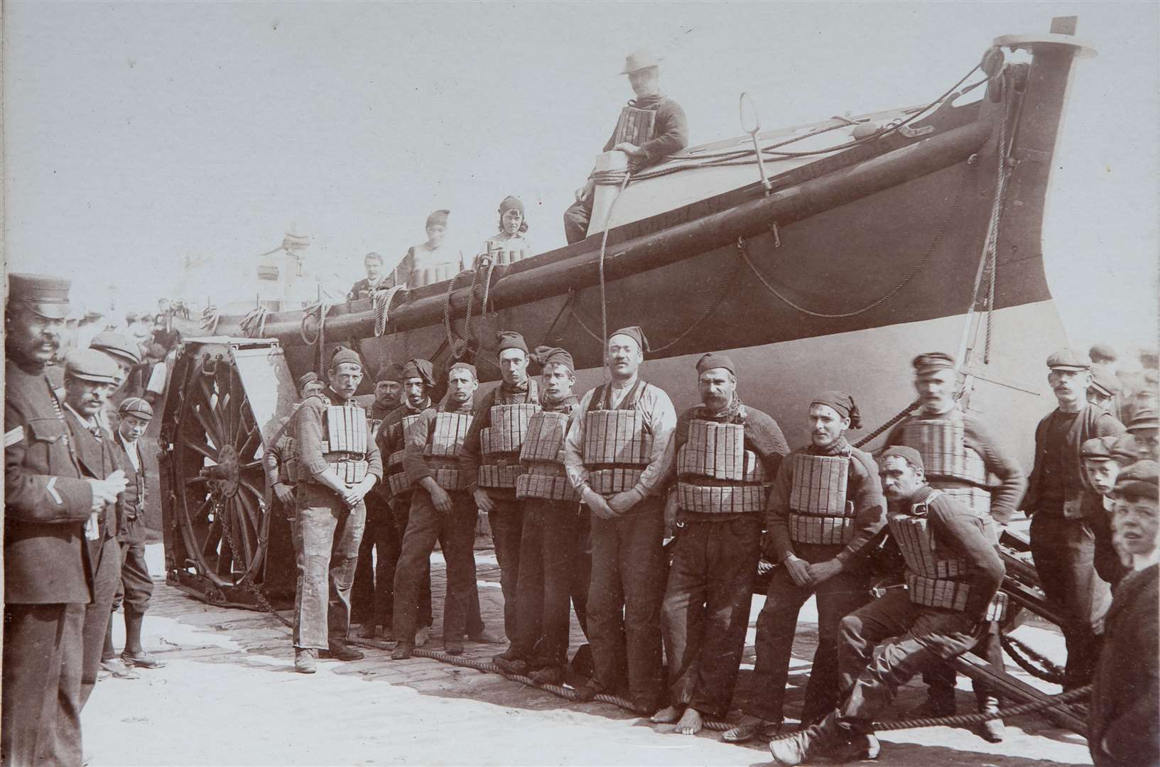 Cork lifejackets were the first lifesaving devices to be issued to crews but had to be flexible enough for men as they rowed. Pictured are Whitby crews circa 1900 with their kit. Image: RNLI.