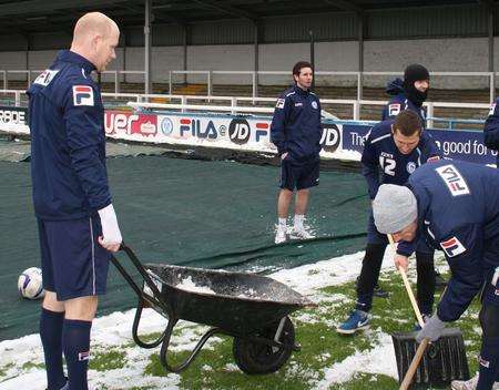 Rochdale attempt to shift the snow
