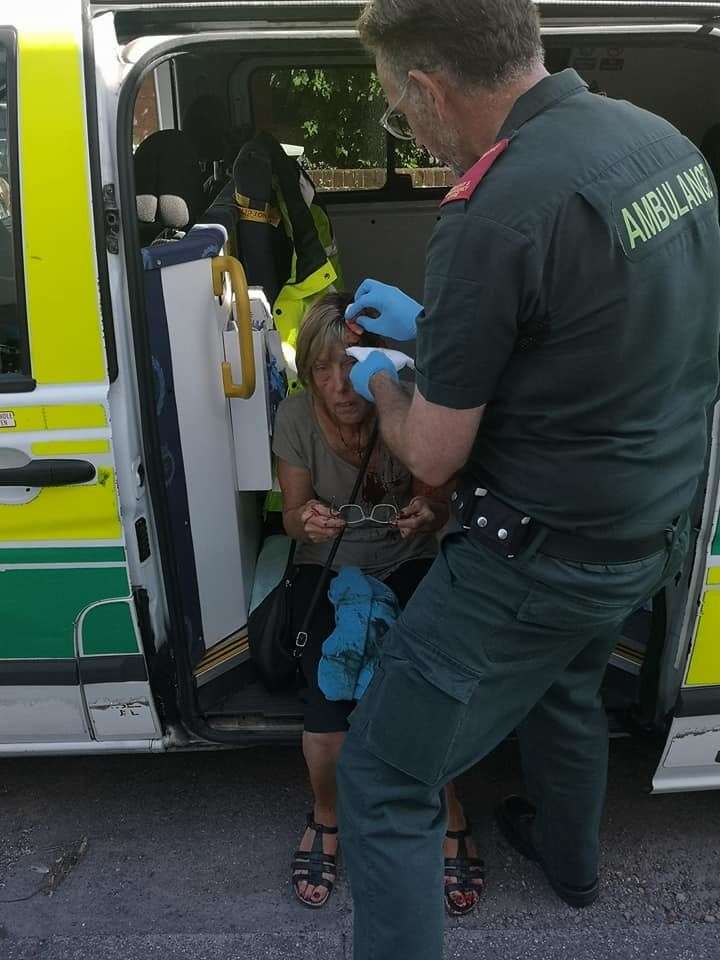 Paramedics treating Mrs Thrumble after the attack