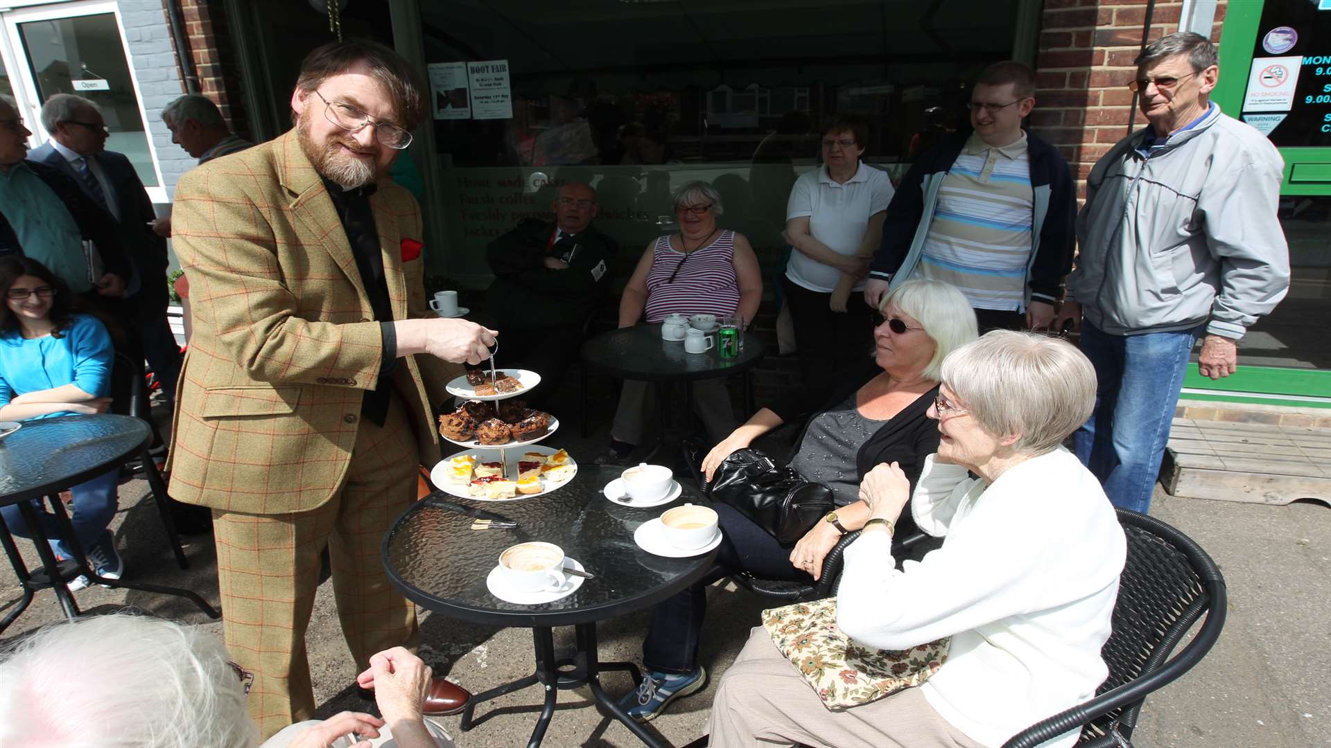 The Rev Nigel Bourne, vicar of Chalk, hands out cakes to guests