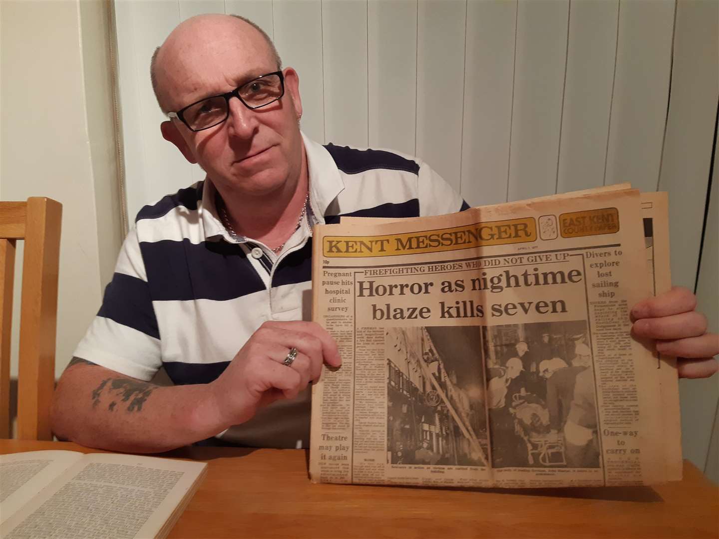 Barry Davison with a 1977 KM newspaper covering the fire. Library image