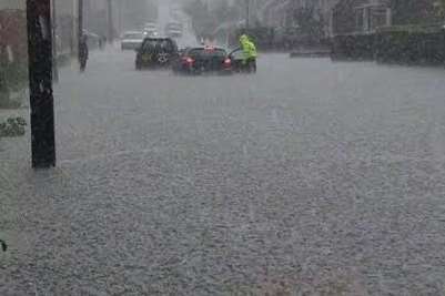 A road in Teynham is left completely underwater during a flash flood. Picture: @Kent_999s