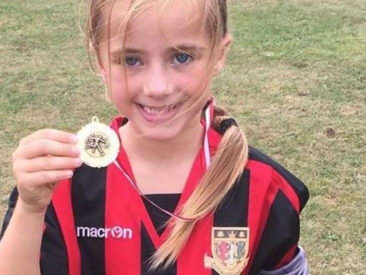 Annie Boichat with a football medal when she was younger
