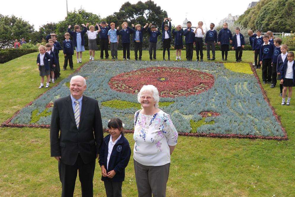 The winning First World War themed poppy flowerbed by schoolgirl Viktoria Koltoova. With her are Shepway cabinet member Malcolm Dearden and Ann Berry of the war commemoration charity Step Short.