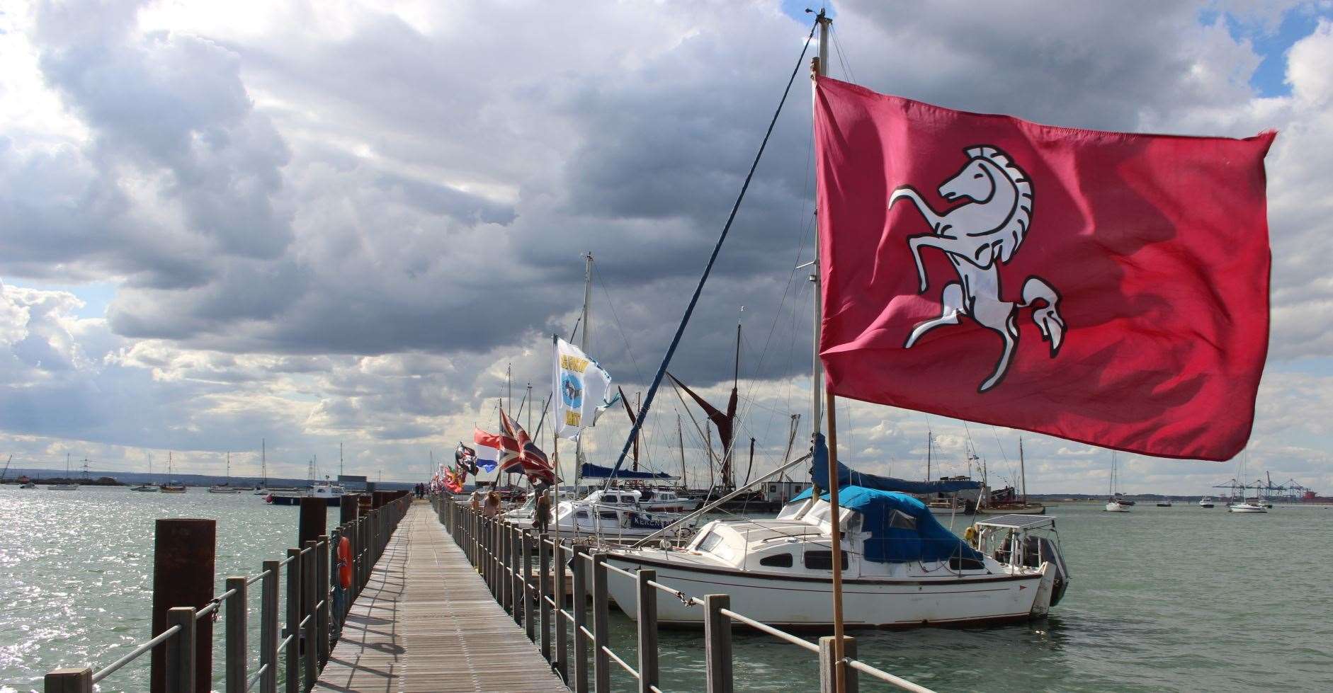 The Invicta Kent flag flying on the all-tide landing stage at Queenborough, as part of the classic boat festival