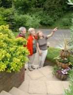 Sheila Townson shows Colin and Julie Ellender round her garden at Valley View
