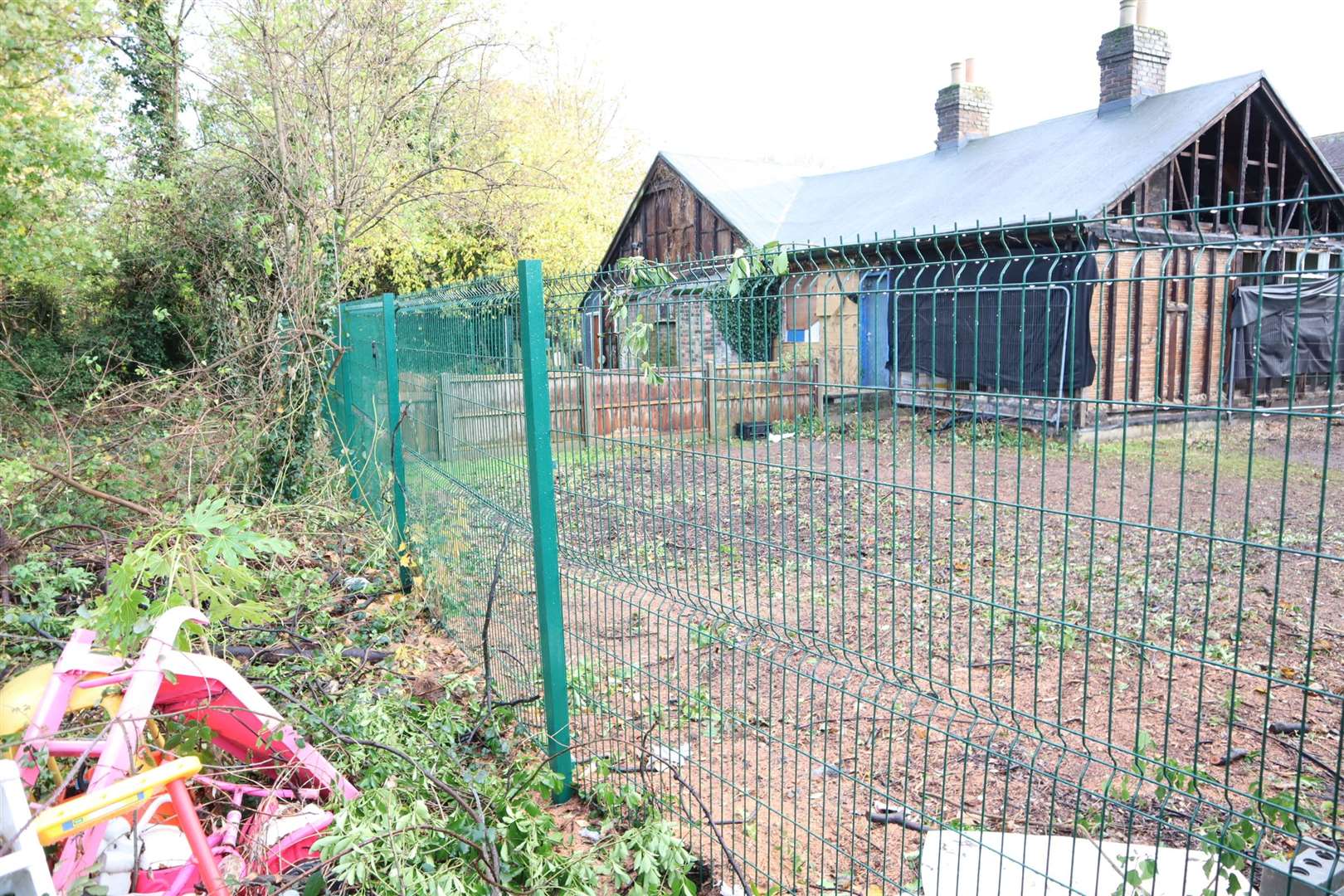 Dumped children's toys and trees removed outside the old nursery hall at Murston