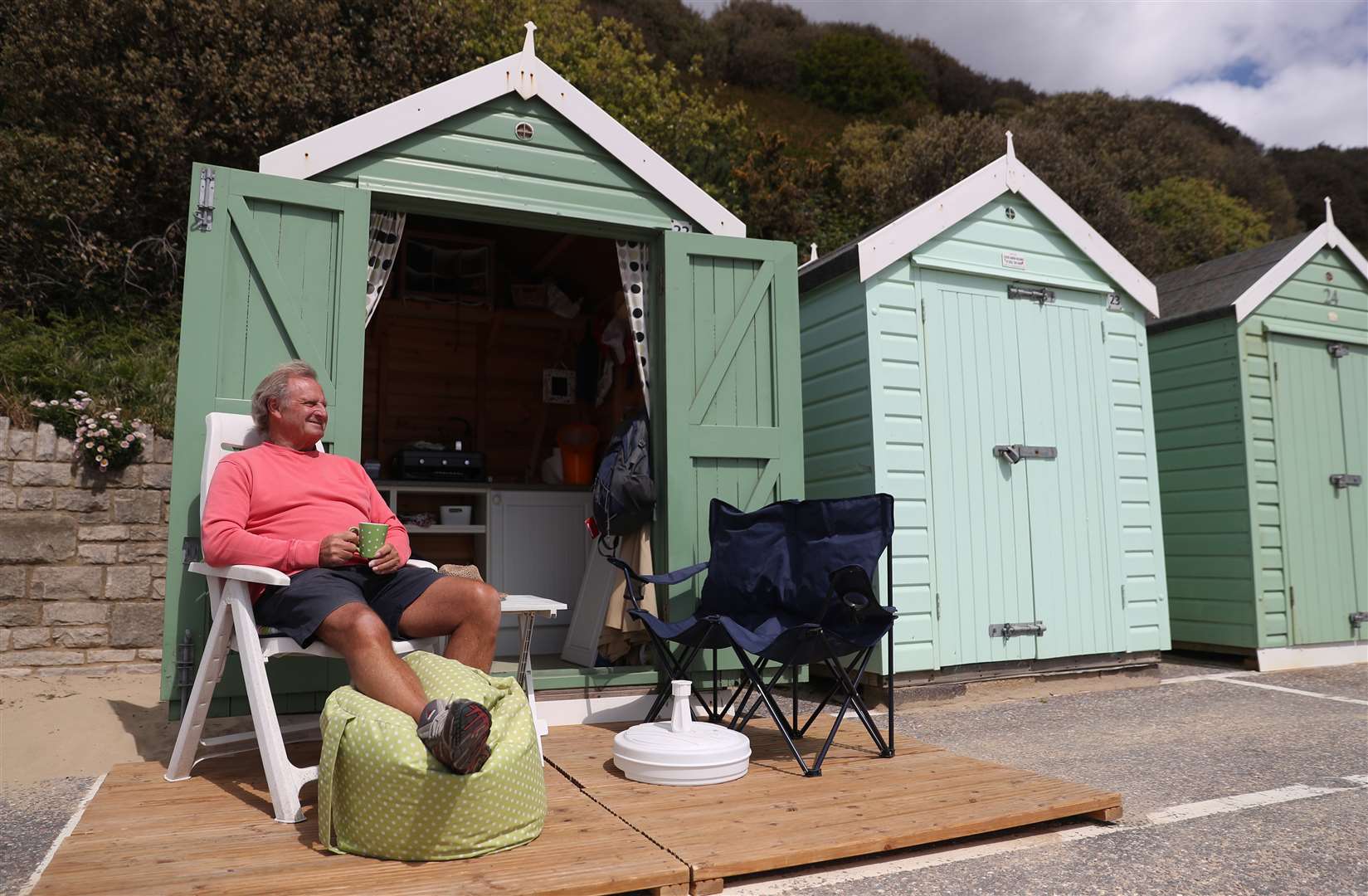 Rob Underhill looks out to sea as he sits outside his beach hut at Bournemouth (Andrew Matthews/PA)