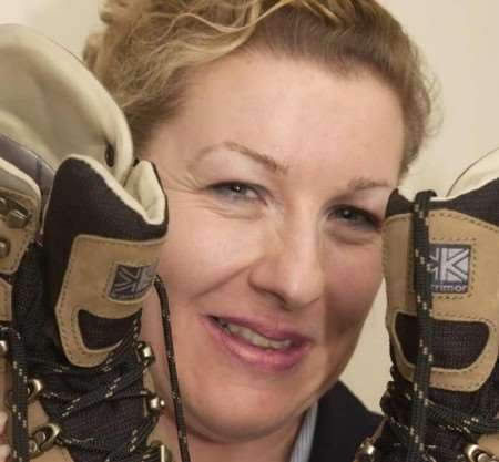 BIG CHALLENGE: Jacqui Buxton with her boots made for walking. Picture: GARY BROWNE