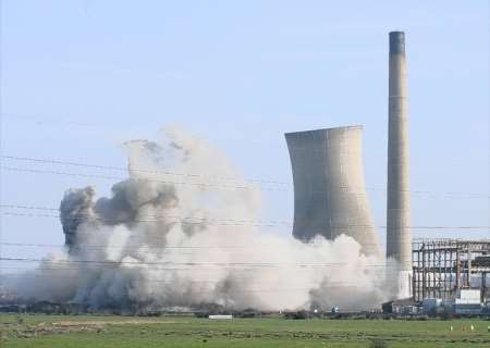 The cooling towers and chimney at the former Richborough power station are demolished