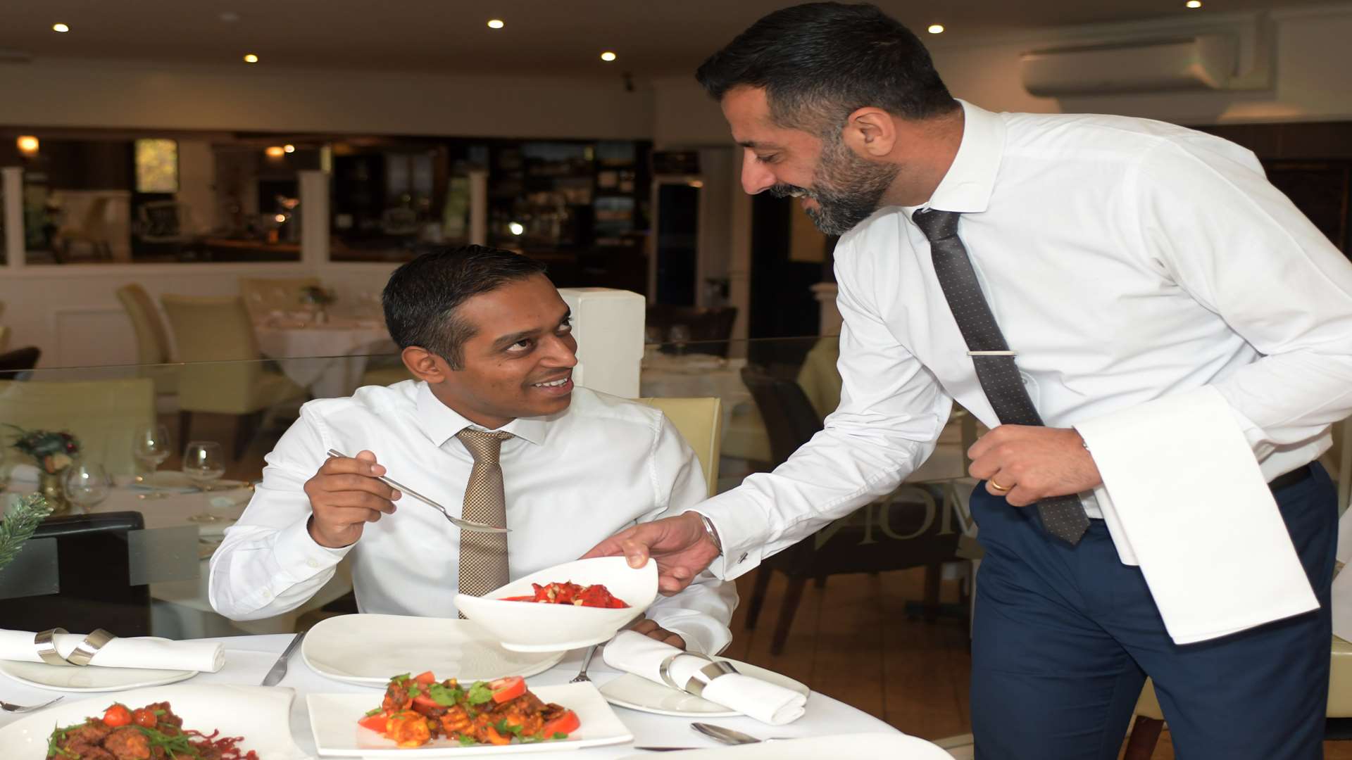 Habib Siddiq of Cinnamon Square, left, is served one of his own dishes by Sukh Majhail from Royal Bank of Scotland