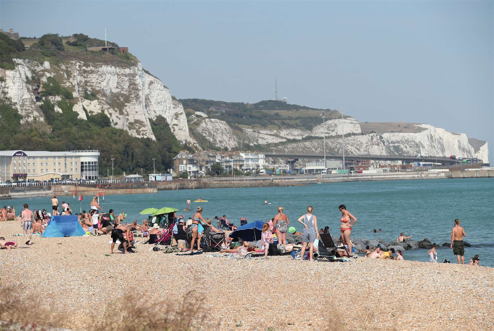 People enjoying the warm weather on a beach in Dover over the weekend (Yui Mok/PA)