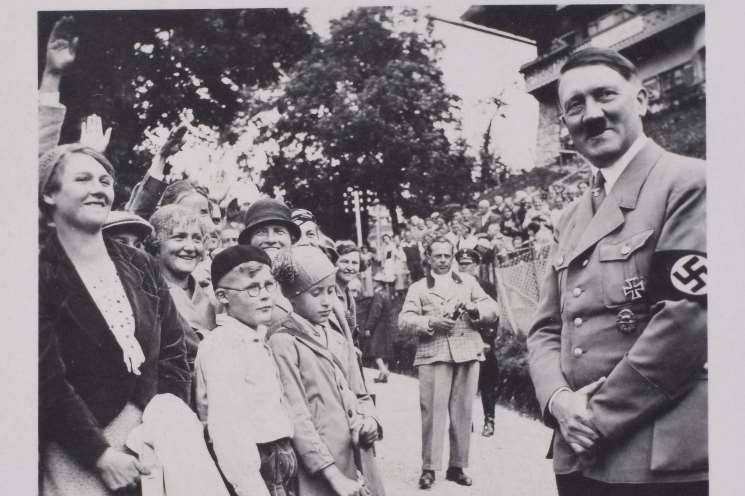 A relaxed Hitler meets saluting crowds. Picture from C&T Auctioneers and Valuers.