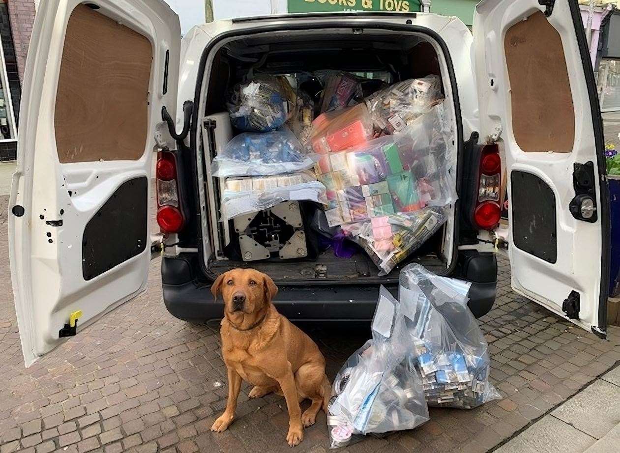 Cooper the detection dog with the illegal vapes seized in Folkestone. Picture: KCC