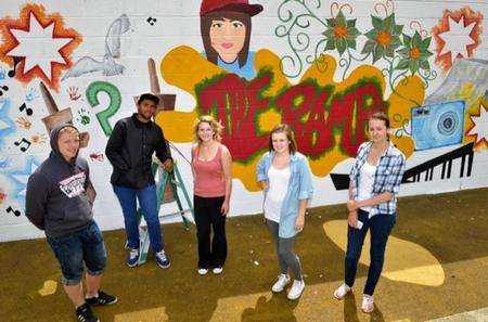From left, artists Matthew Martin, 18, Kyle Chan, 19, Rowan Ellis, 17, Larissa Walton, 18, and Hannah Silk, 17 by their mural on the wall of the skate park