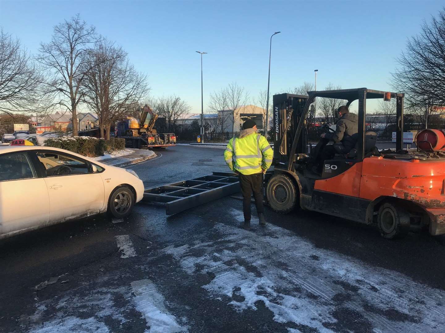 A forklift moves the steel out of the road after it came off the back of a lorry on the Medway City Estate