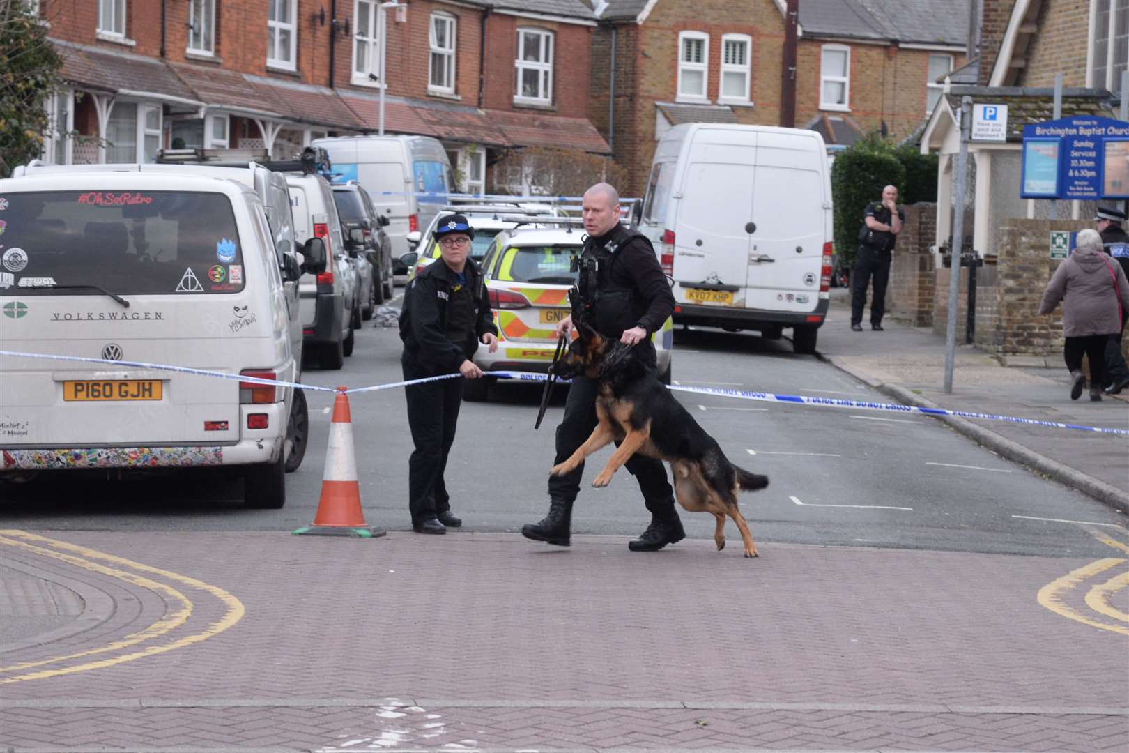 Police dog handler at the scene in Crescent Road, Birchington on Sunday. Picture: Chris Davey.