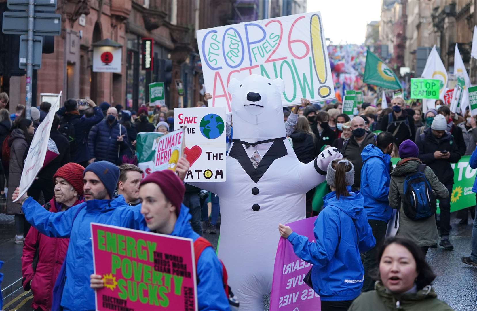 Marchers with placards and wearing fancy dress thronged the streets despite the weather in Glasgow (Jane Barlow/PA)