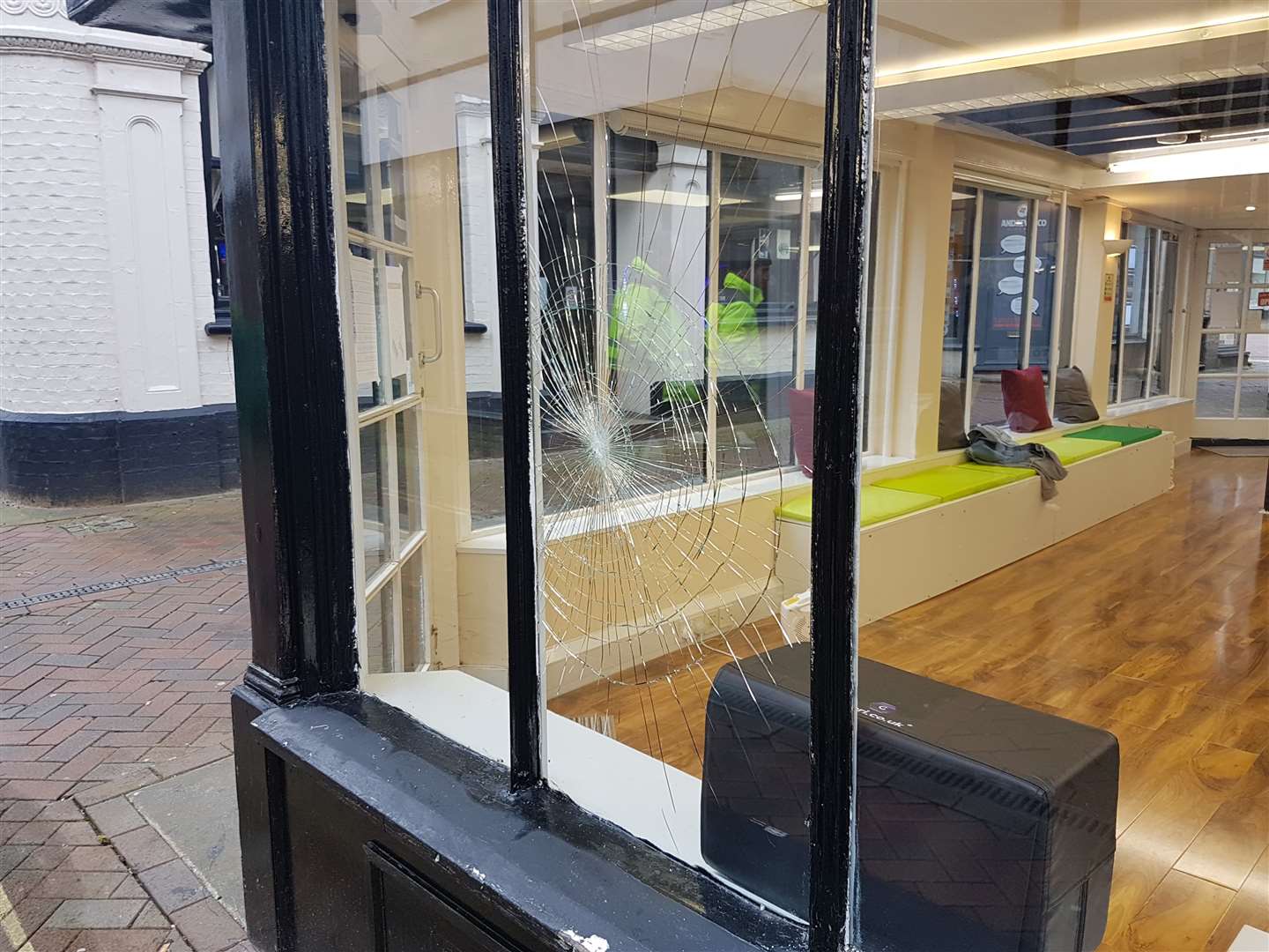 The window of HD Barber's was damaged during the incident