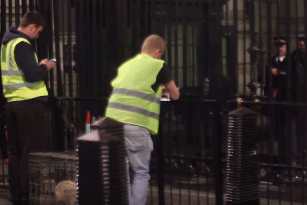 Daniel Jarvis (left) pretending to be a delivery man at the gates of Downing Street during a previous prank