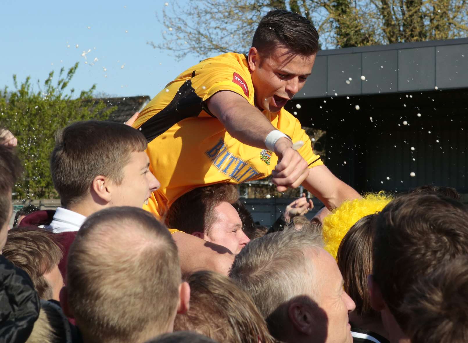 Maidstone players were carried from the field of play during the post-match celebrations. Picture: Martin Apps