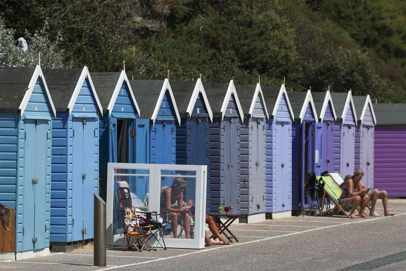 People use their beach huts in Bournemouth (Steve Parsons/PA)